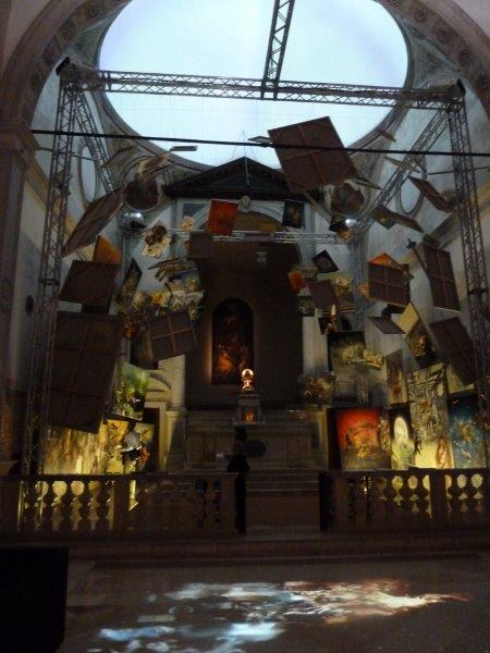 Church space filled with hanging paintings as art instalation